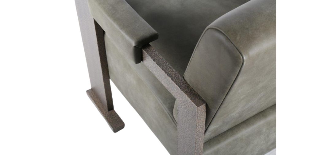 Close up of FBC London SOL collection bespoke luxury armchair in grey with planished bronze frame.
