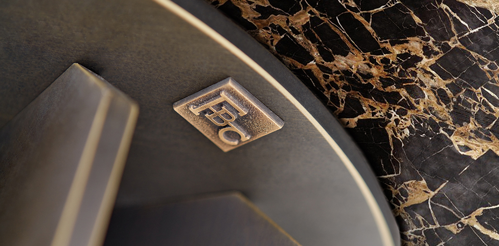 FBC signature bronze cast badge with luxury furniture brand logo.